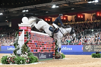 Guy Williams and Mr Blue Sky UK lift their third consecutive Puissance title at the London International Horse Show